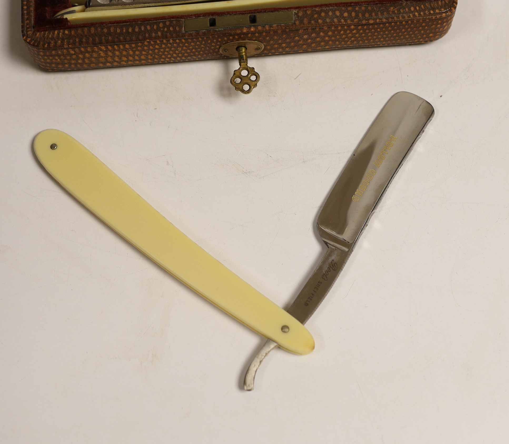 A cased set of cut throat razors, faux ivory handles, Monday - Sunday etched on blades